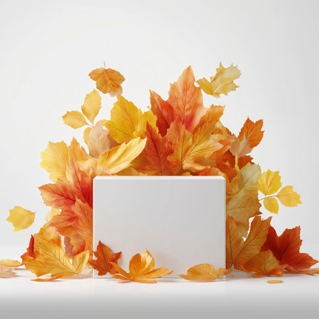 Minimalist podium scene featuring colorful autumn leaves surrounding a white pedestal, suitable for product showcases and seasonal marketing.の素材