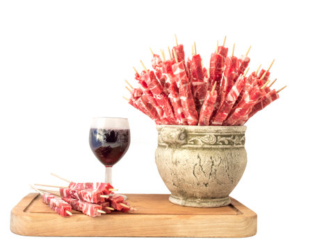 Skewers of meat and a glass of red wineの写真素材