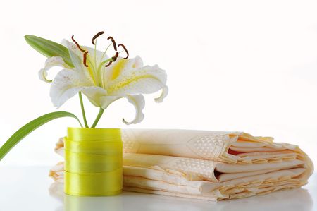 Lily and tablecloth against the white backgroundの写真素材