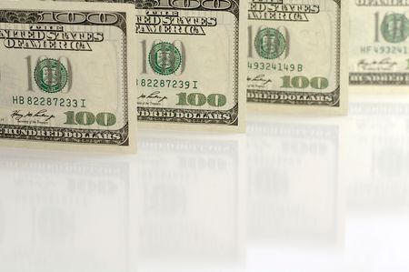 One hundred dollar notes against the white backgroundの写真素材