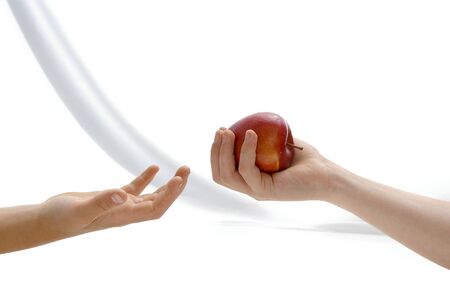 One child proposes apple to another child の写真素材