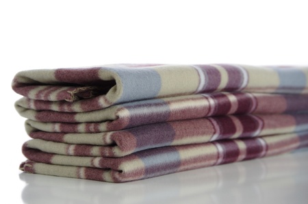 Accurately folded warm blanket against the white backgroundの写真素材