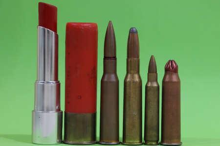 set of bullets and one lipstick against a green background