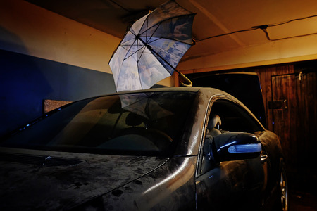 dusty old car in the garageの写真素材