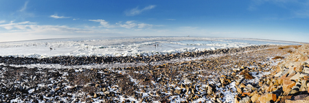 winter fishing on the sea the bright sunの写真素材