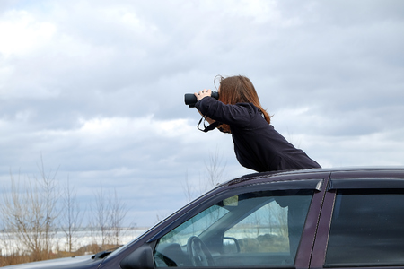 young girl looking through binocularsの写真素材