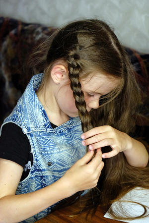 girl combing her hairの写真素材