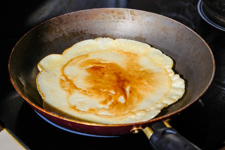 a pancake fried in a skilletの写真素材