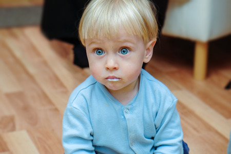 portrait of little boy smeared porridgeの写真素材