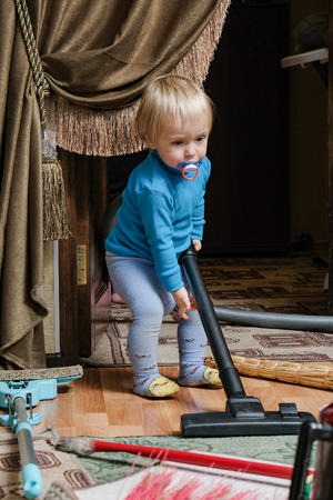 child vacuuming a roomの写真素材
