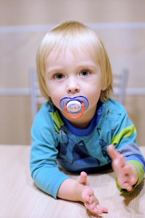 cute baby at the tableの写真素材