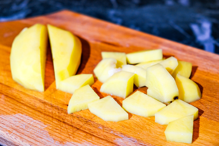raw potatoes and onions on the cutting Boardの写真素材
