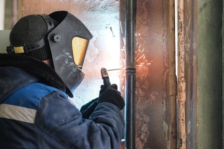 the welder welds metal structures