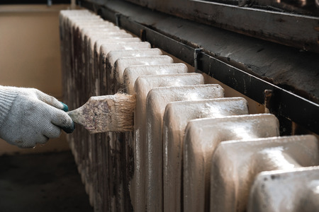 worker paints the metal water heating radiatorの写真素材