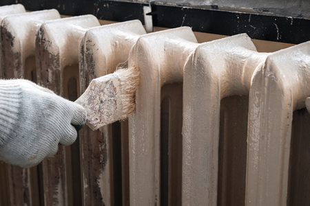worker paints the metal water heating radiatorの写真素材