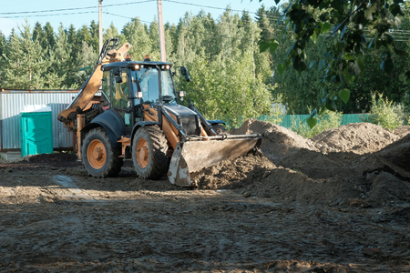 the tractor works at the construction site