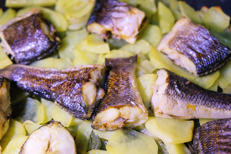 fresh pink salmon potatoes and onions on a baking sheet