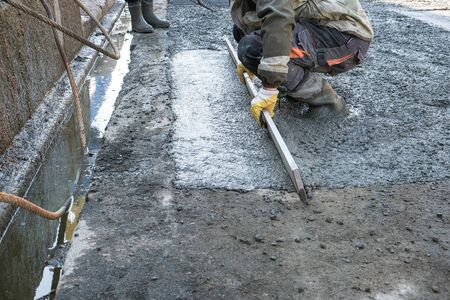 builders poured concrete at the construction siteの写真素材