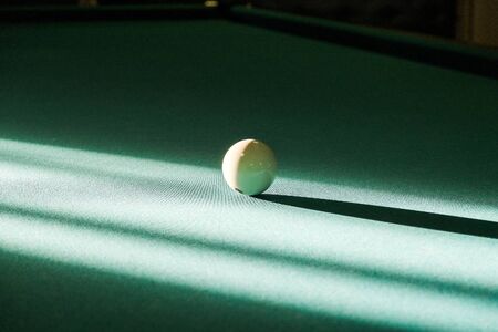 billiard ball in the rays of light on the billiard tableの写真素材