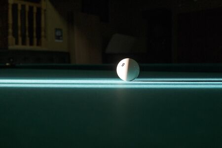 billiard ball in the rays of light on the billiard table