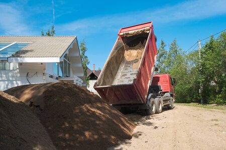 truck pours sand on the construction siteの写真素材