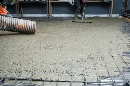 the builders poured concrete at the construction siteの写真素材