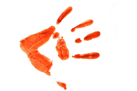 track of palm on the white sheet of paper, done a red paintの写真素材