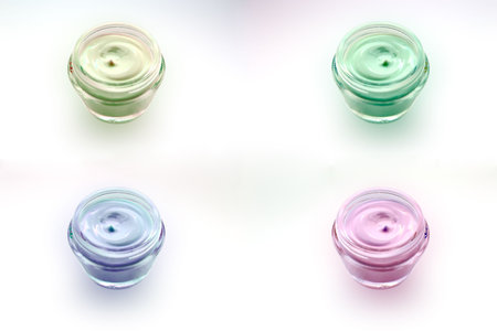varicoloured cream for a body and person, utillized for the rejuvenation of skin on a white backgroundの写真素材