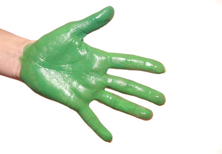 a womanish palm is painted green paints on a white backgroundの写真素材