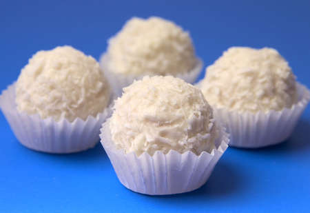 appetizing candies with a nut and coconut are sparse on a white background