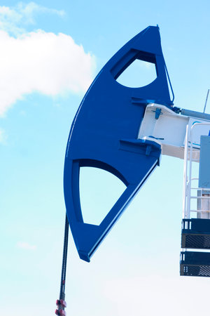 The girder of a working petrorocking chair on a background of the blue skyの写真素材