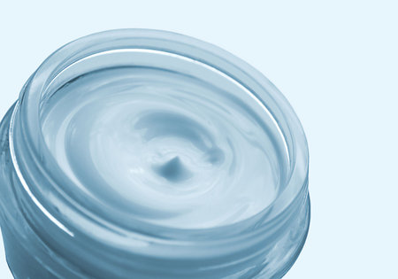 Cosmetic cream for care of a body in round container in blue tonesの写真素材