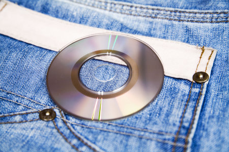 compact disk with modern music against fashionable blue jeansの写真素材