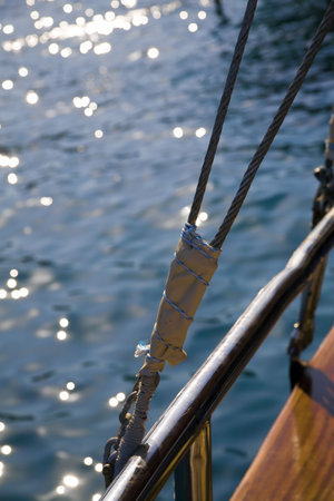 rigging of sail ship and sea waves with the sun specks of light