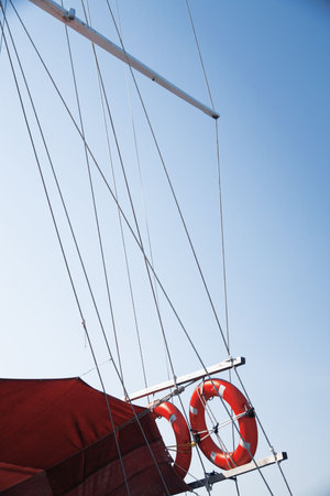 red lifebuoy of ship on a background a blue skyの写真素材