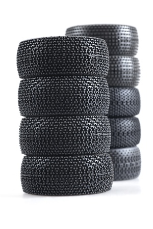 stack of spare auto tires on a white backgroundの写真素材