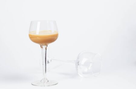 cream liqueur in a glass on a white backgroundの写真素材