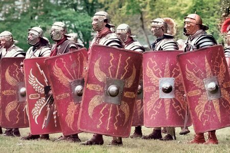 Gessate, Milan, Italy: April 07, 2019: reenactment of ancient Roman legionary soldiers during battle against Gallic army and life scene in war training camp with several duelingのeditorial素材