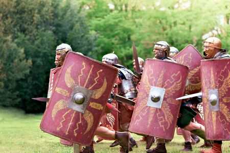 Gessate, Milan, Italy: April 07, 2019: reenactment of ancient Roman legionary soldiers during battle against Gallic army and life scene in war training camp with several duelingのeditorial素材