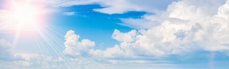 Bright sun in the blue sky with clouds panoramic view.の写真素材