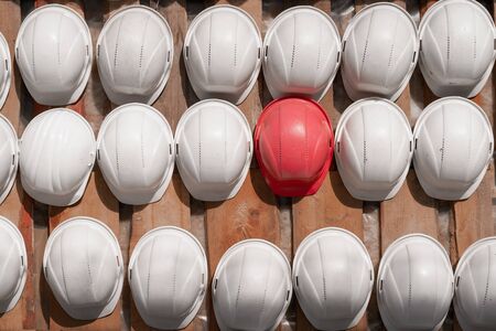 Safety helmets hanging on a wooden shield.の写真素材