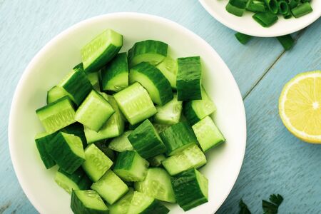 Top view bowl of chopped cucumber for salad.の写真素材