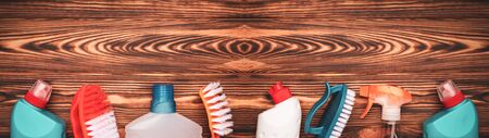 Top view supplies for cleaning on wooden background the web banner with copy space.