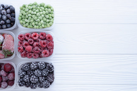 Top view of frozen berries in boxes on white background with place for text.の写真素材