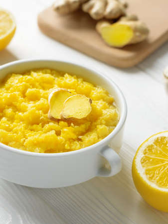 Natural home made remedy that will make immune system stronger and powerful with lemon and ginger with garlic vertical shot.の写真素材