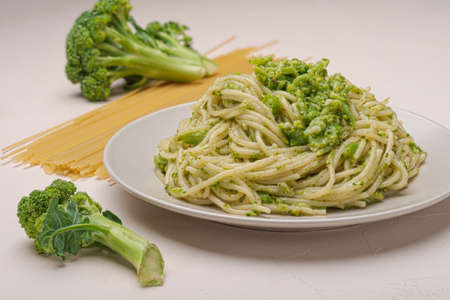 Close-up of a plate of pasta with broccoli on a light backgroundの写真素材