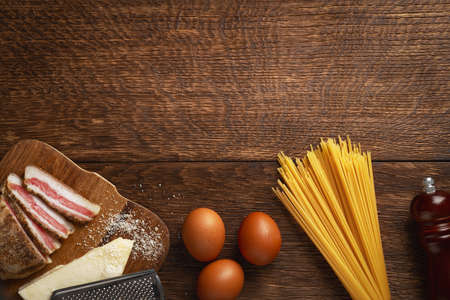 Ingredients for spaghetti carbonara on a wooden table with copy spaceの写真素材