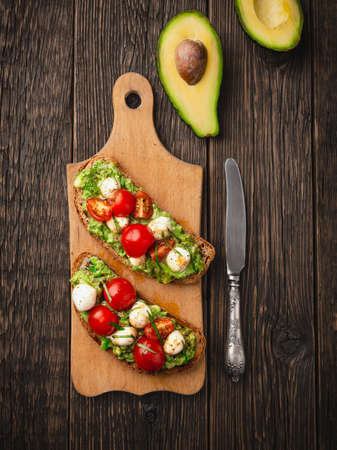 Avocado toast with mozzarella and cherry tomatoes vertical frameの写真素材