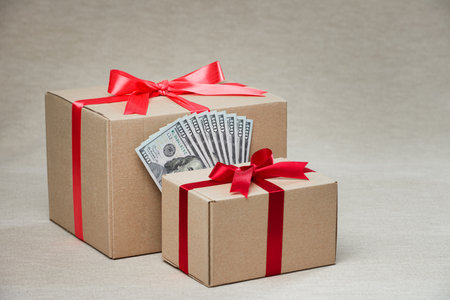 Gift boxes and dollar bills. Close up with copy space. studio shot.の写真素材