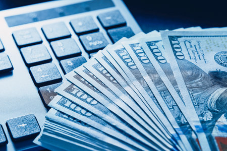 Close-up of one hundred dollar banknotes and computer numeric keypad. no people.の写真素材